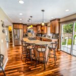 Bright and modern luxury kitchen with clean lines and high-end finishes, staged professionally to appeal to potential home...