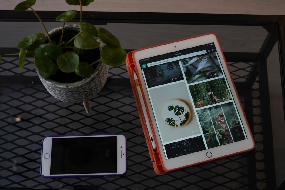 Close-up of a tablet and smartphone displaying a modern luxury home, illustrating a multi-device digital real estate marke...