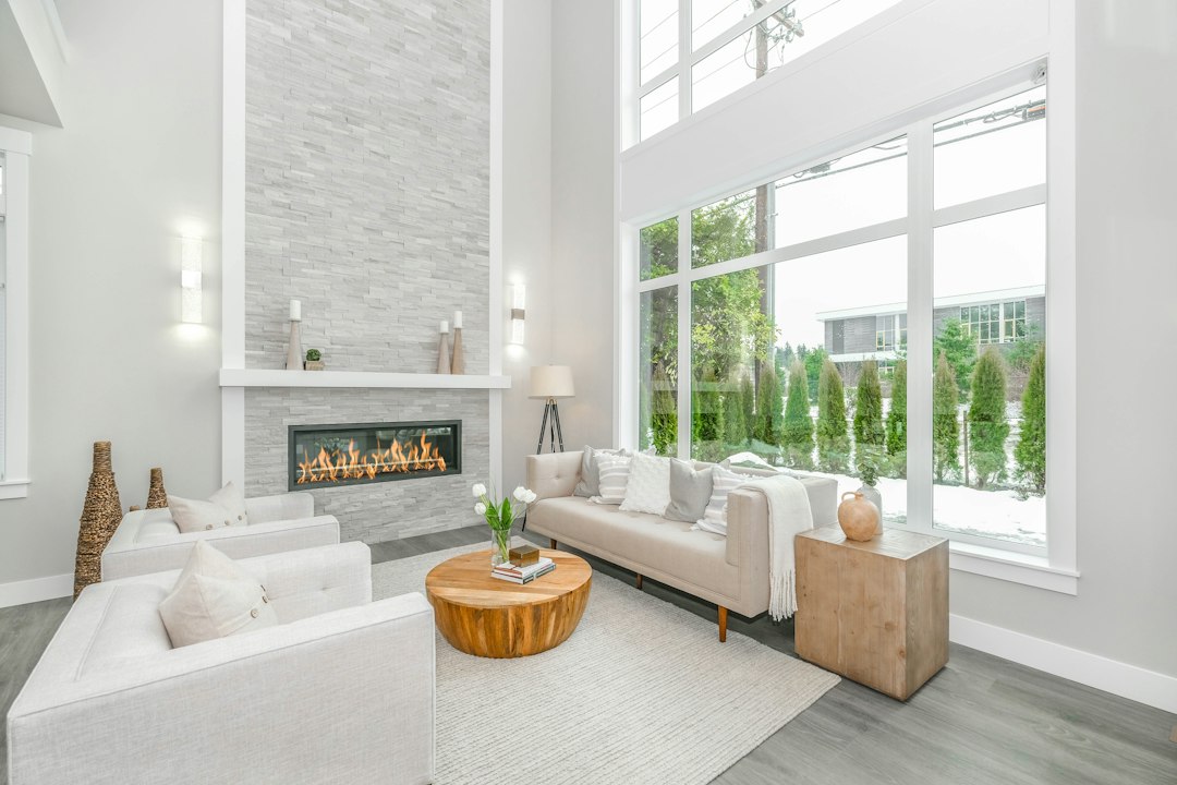 A person sitting comfortably in a bright, airy, and modern living room, embodying the peace of mind that comes from a financially secure home.